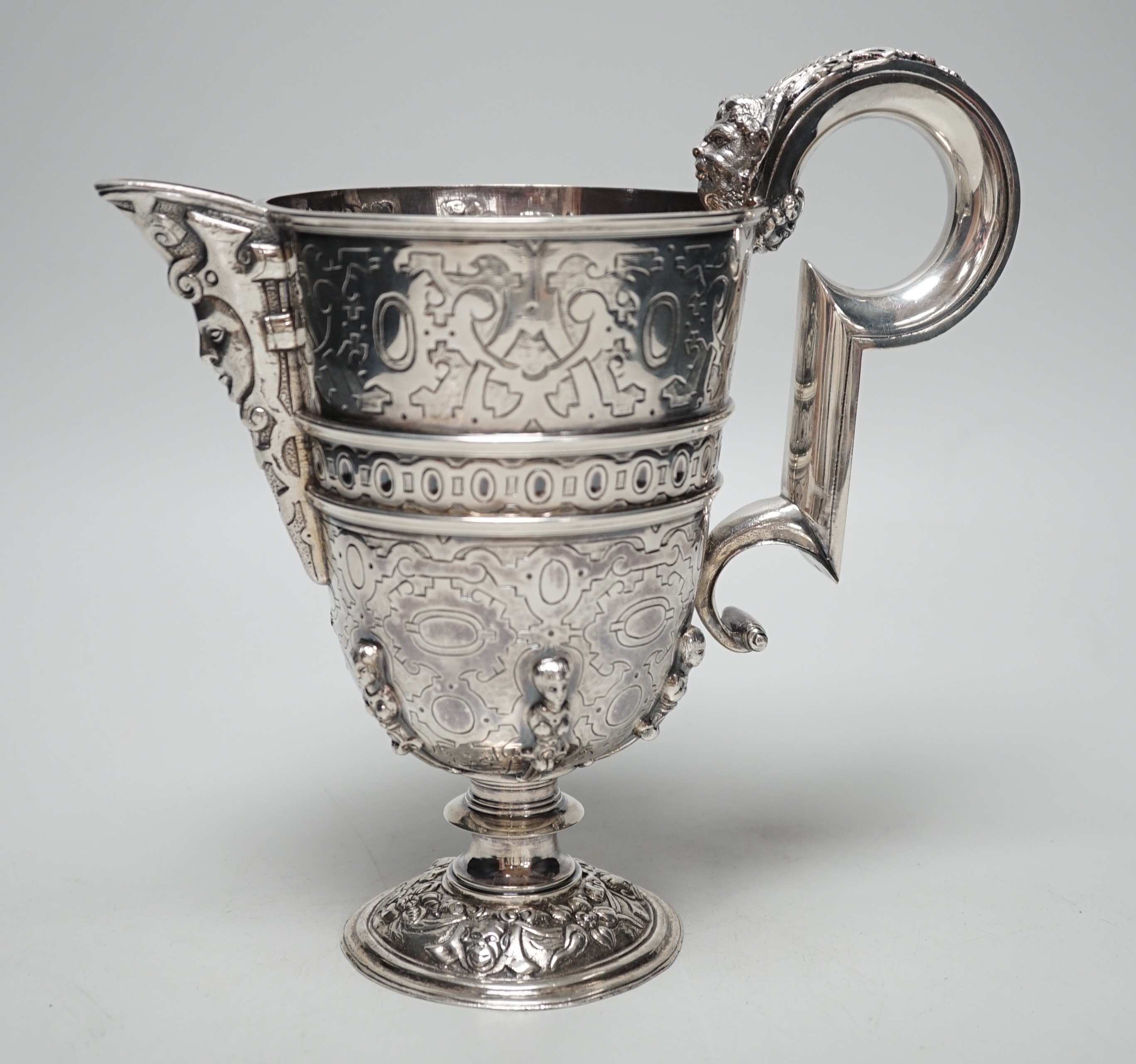 A mid 20th century Spanish? white metal ewer, with engraved, caryatid and mask decoration, height 22.2cm, 26.7oz.